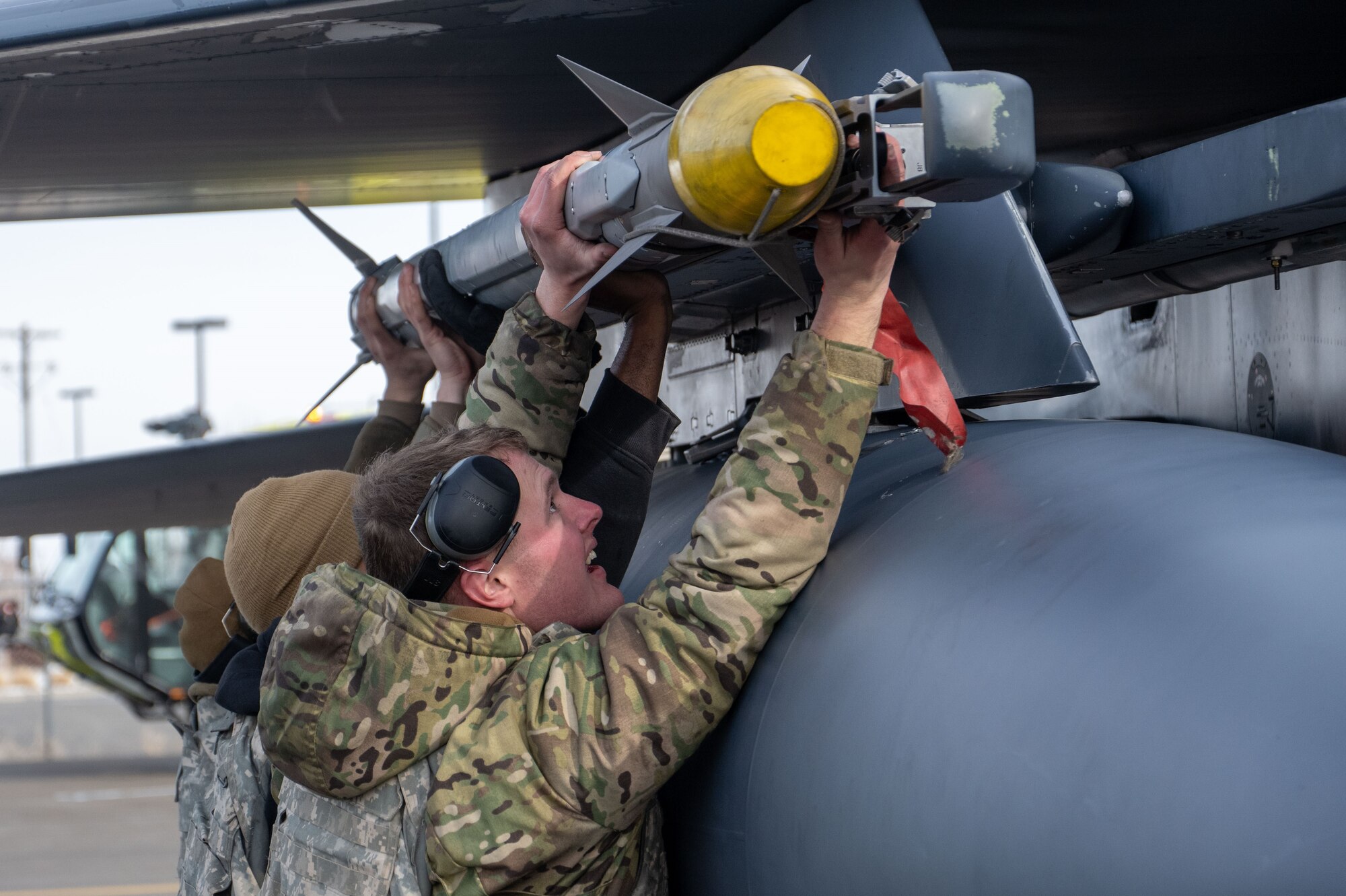 Photo of Airmen loading munitions