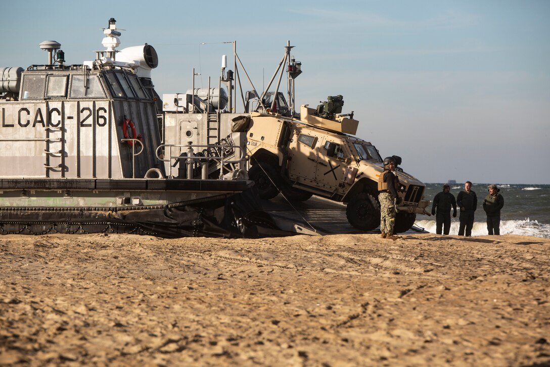 U.S. Marines with 2nd Marine Division and Sailors with U.S. Second Fleet, unload Joint Light Tactical Vehicles during Amphibious Exercise 2023 at Joint Expeditionary Base Little Creek-Fort Story, Virginia, Feb. 1, 2023. Familiarization with U.S. Navy landing craft, air cushions and simulated amphibious beach landings were an essential aspect of AMPHEX in order to increase proficiency in ship to shore movement capabilities. AMPHEX is a joint service exercise that demonstrates littoral interoperability and operational maneuver cohesion between the U.S. Marine Corps and U.S. Navy. (U.S. Marine Corps photo by Cpl. Angel Alvarado)