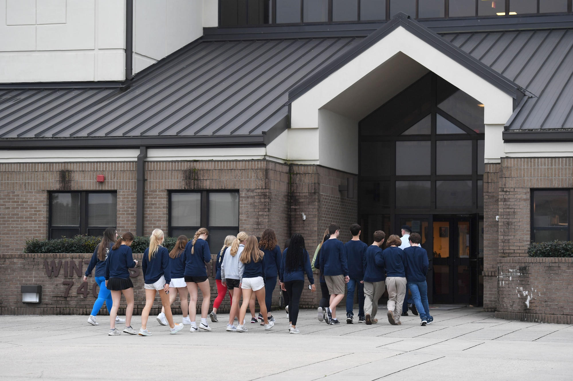 Members of the Biloxi Chamber of Commerce Junior Leadership Program enter Winters Manor for a dorm tour at Keesler Air Force Base, Mississippi, Jan. 31, 2023.