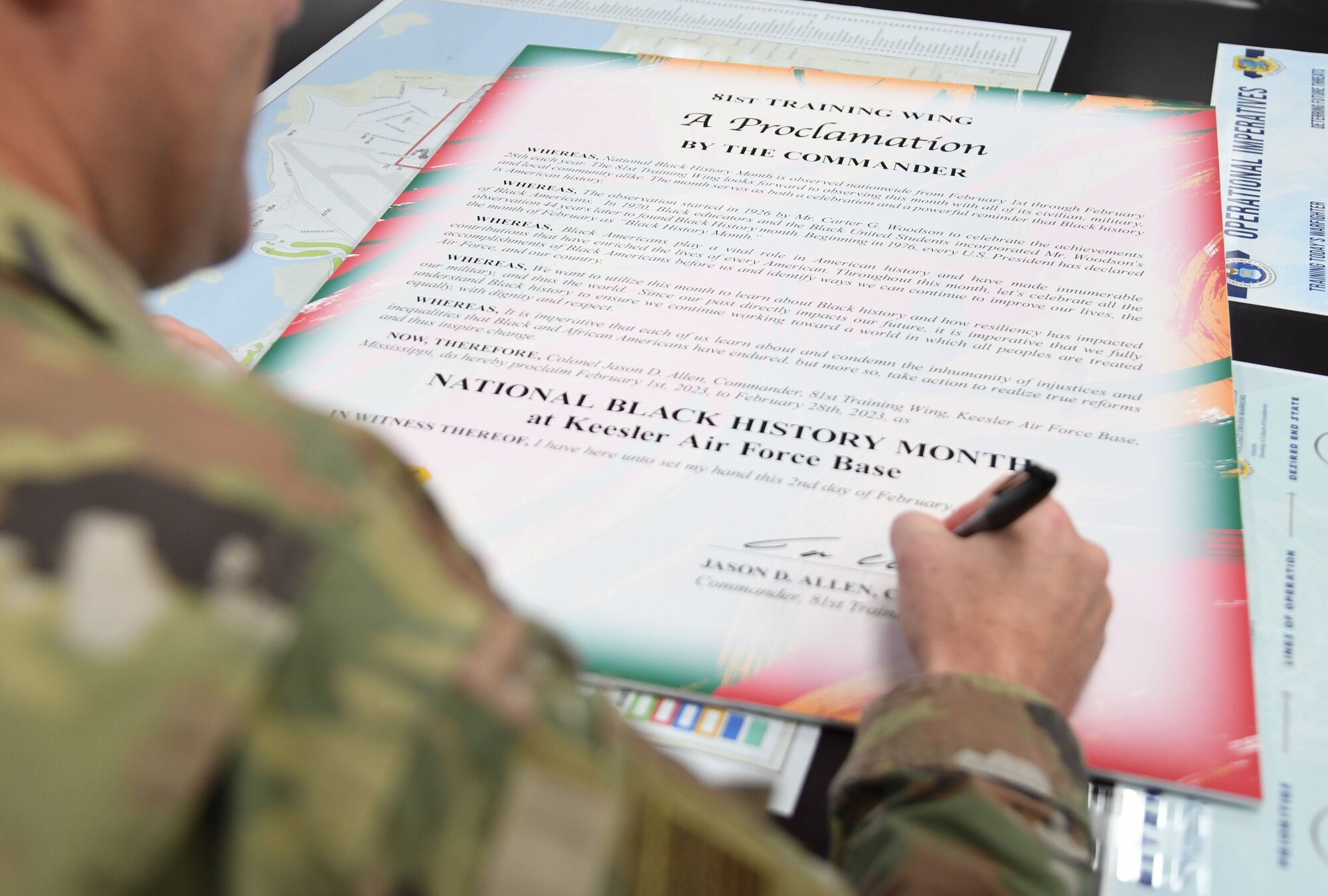 U.S. Air Force Col. Jason Allen, 81st Training Wing commander, signs the National Black History Month proclamation inside the 81st TRW headquarters building at Keesler Air Force Base, Mississippi, Jan. 2, 2023.