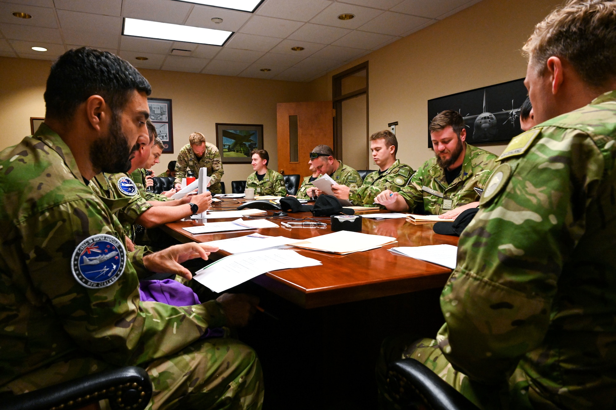 Men in uniform have a meeting.