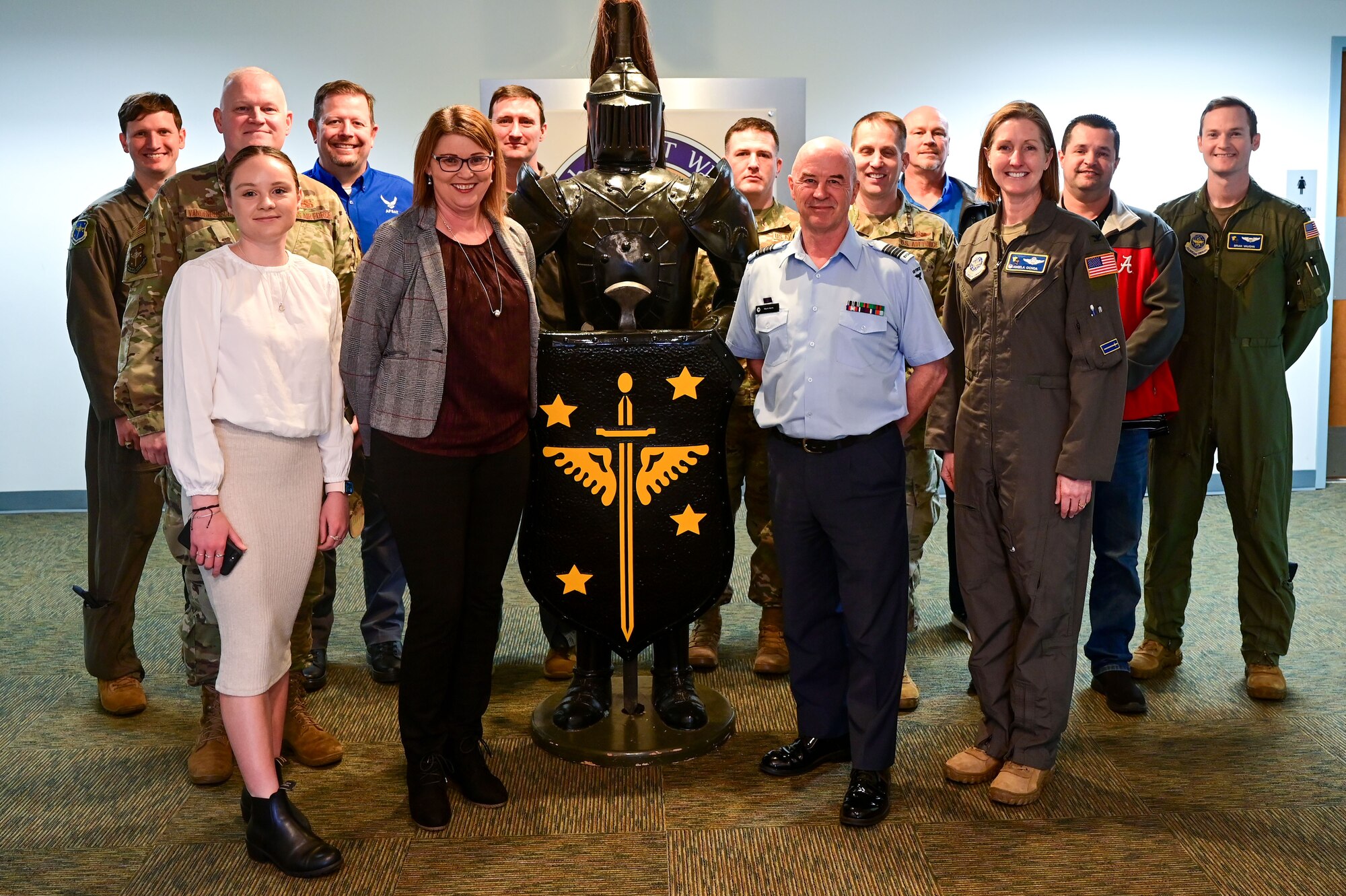 Men and women pose for a photo.