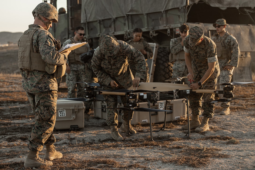 U.S. Marines with 1st Transportation Battalion, Combat Logistics Regiment 1, 1st Marine Logistics Group, assemble the TRV-150 (TRUAS) drone before takeoff during Battalion Field exercise 1-23 on Camp Pendleton, California, Oct. 19, 2022. Battalion FX 1-23 is a 1st Transportation Battalion exercise integrated with Project Convergence 22, where Marines and Sailors leverage a series of joint, multi-domain engagements, integrating artificial intelligence, robotics, and autonomy to enhance warfighting capabilities and accelerate decision-making timelines. (U.S. Marine Corps photo by Cpl. Casandra Lamas)
