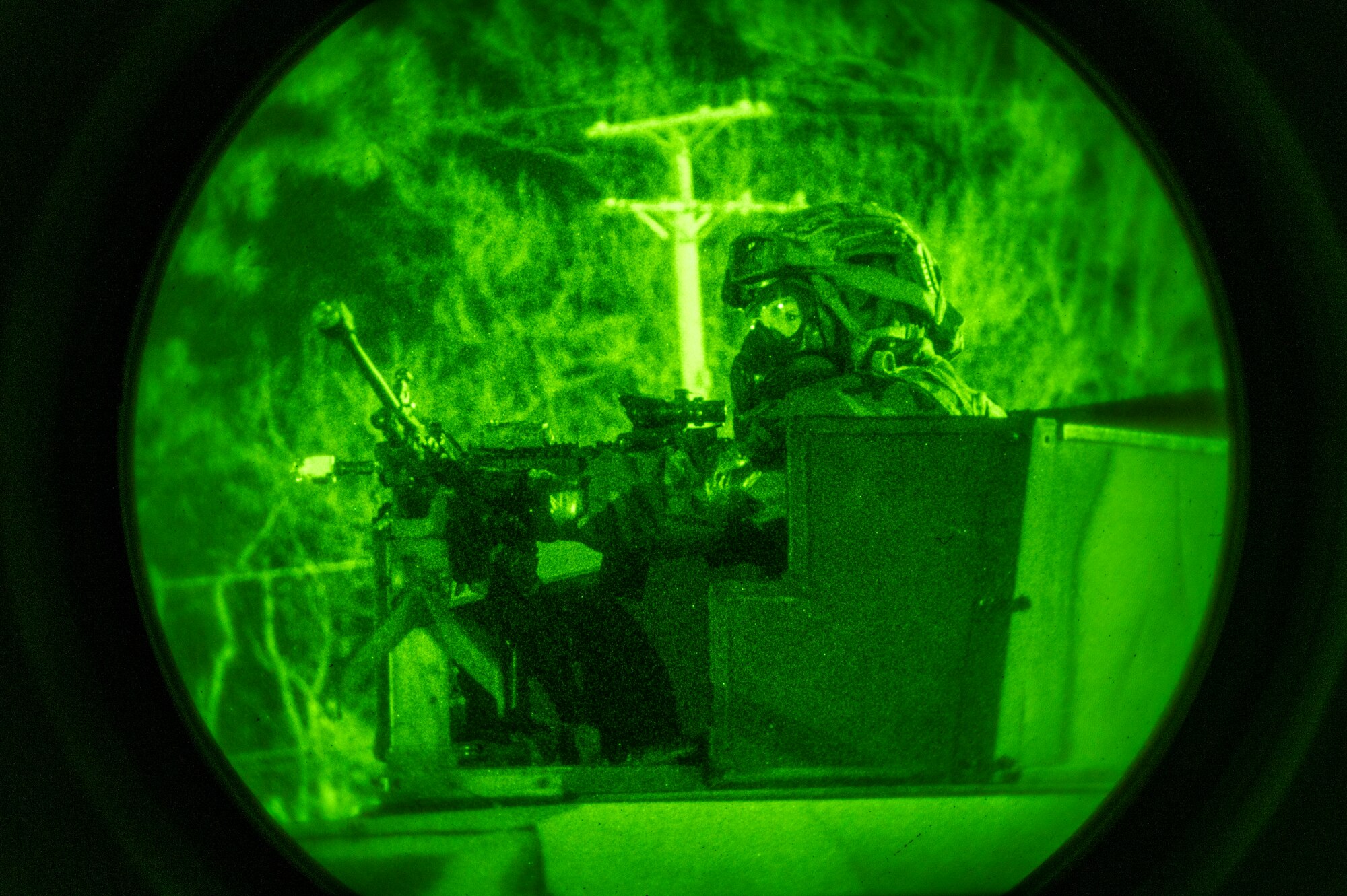 U.S. Air Force 51st Security Forces Squadron Defender scans for simulated opposing forces (OPFOR)  during a night-time base defense training scenario at Osan Air Base, Republic of Korea, Feb. 1, 2023. Humvee gunners are responsible for providing the first line of defense for the vehicle and their team through surveillance, target acquisition and engagement of OPFOR with lethal force. (U.S. Air Force photo by Airman 1st Class Aaron Edwards)