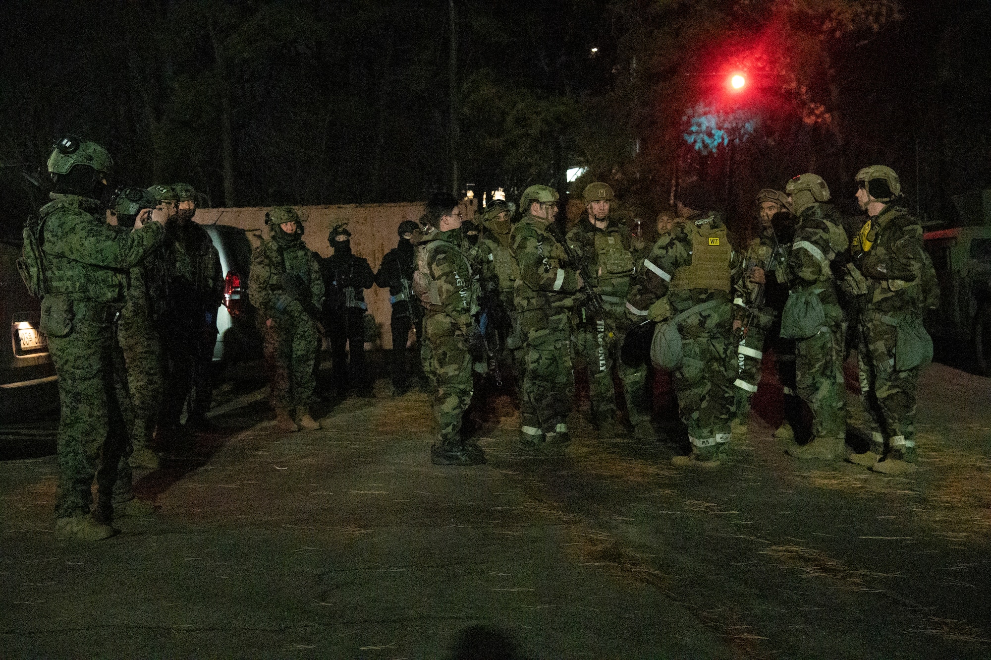 51st Security Forces Squadron Defenders and Republic of Korea Military Police members debrief after a night-time base defense training scenario at Osan Air Base, Republic of Korea, Jan. 31, 2023. During debrief, Wing Inspection Team (WIT) members took time to discuss defender’s performance as well as areas for improvement in base defense operations. (U.S. Air Force photo by Airman 1st Class Aaron Edwards)