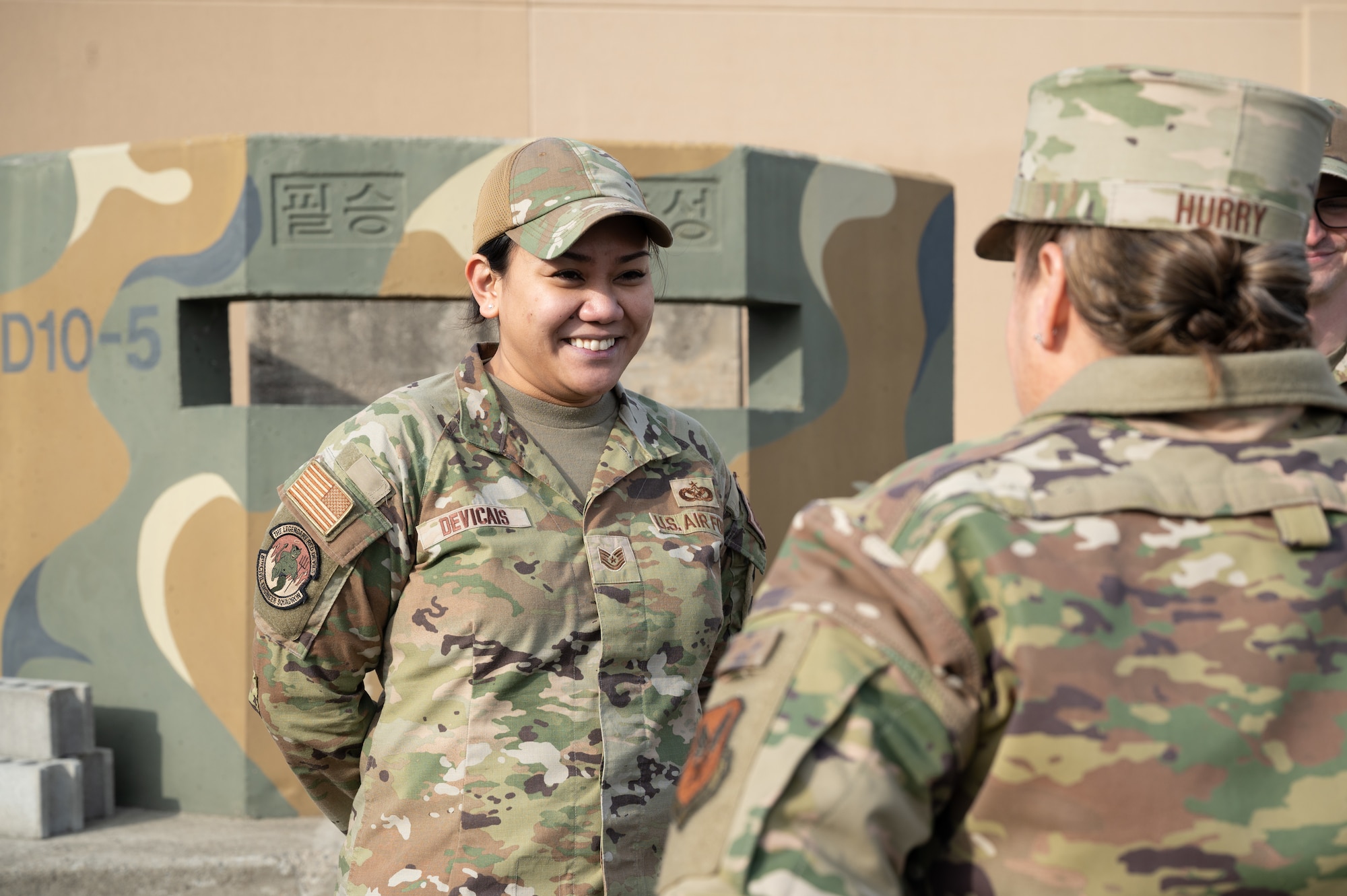 Tech. Sgt. Soleil Devicais (left), 8th Civil Engineer Squadron expeditionary engineering NCO in charge, speaks with Maj. Gen. Linda S. Hurry, director of logistics, deputy chief of staff for logistics, engineering and force protection, Headquarters Air Force, at Kunsan Air Base, Republic of Korea, Feb. 1, 2023. Several Airmen got to explain their flight’s mission as they operate to support the 8th Fighter Wing’s logistical movements. (U.S. Air Force photo by Staff Sgt. Sadie Colbert)