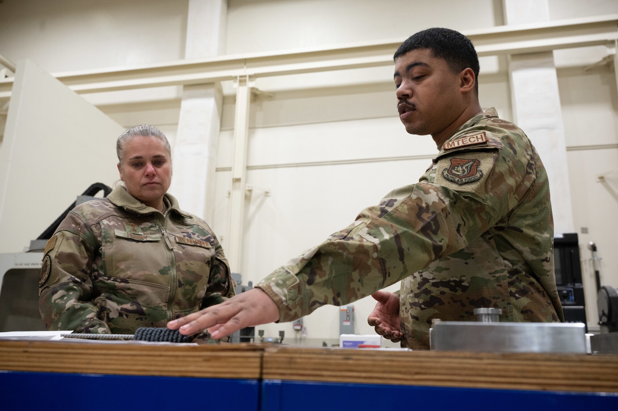 Maj. Gen. Linda S. Hurry (left), director of logistics, deputy chief of staff for logistics, engineering and force protection, Headquarters Air Force, receives a briefing from Staff Sgt. Dontie Custis, 8th Maintenance Squadron aircraft metals technology day shift lead, at Kunsan Air Base, Republic of Korea, Feb. 1, 2023. The flight showcased their skills to fabricate critical parts which extend asset serviceability. (U.S. Air Force photo by Staff Sgt. Sadie Colbert)