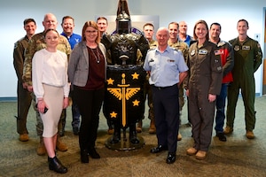 Men and women pose for a photo.