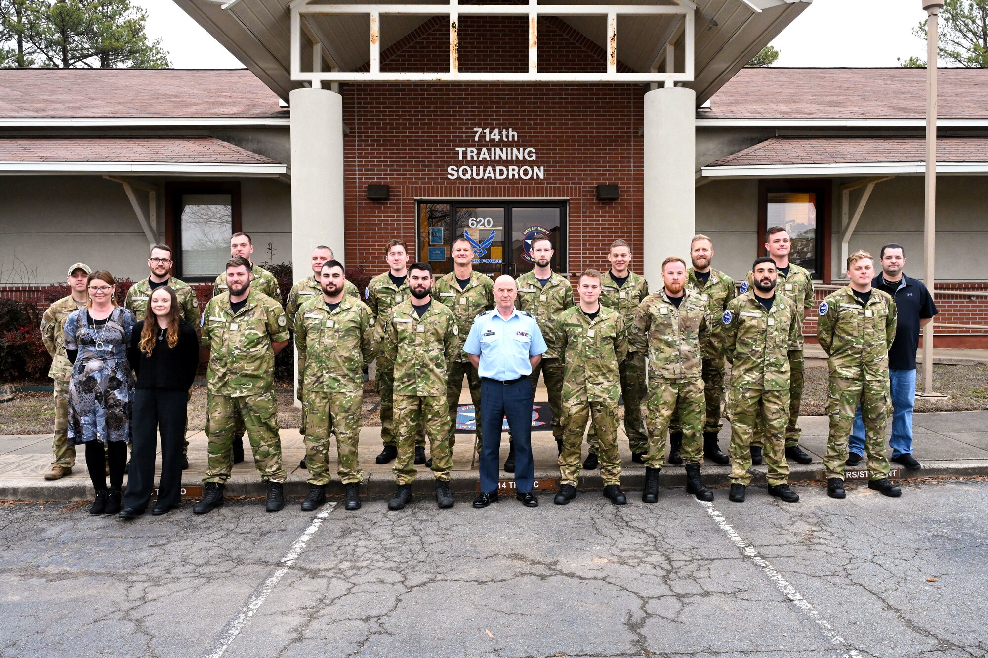 Men and women pose for a photo.