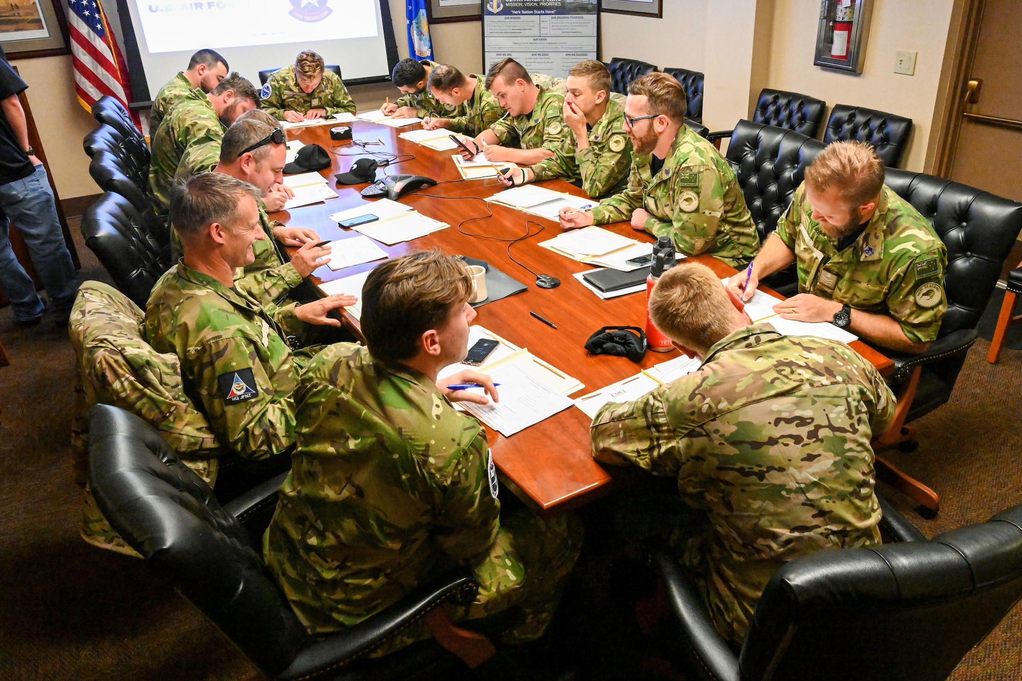 Men in uniform have a meeting.