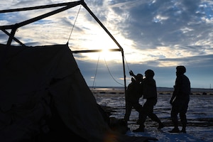 Photo of Airmen assembling tent