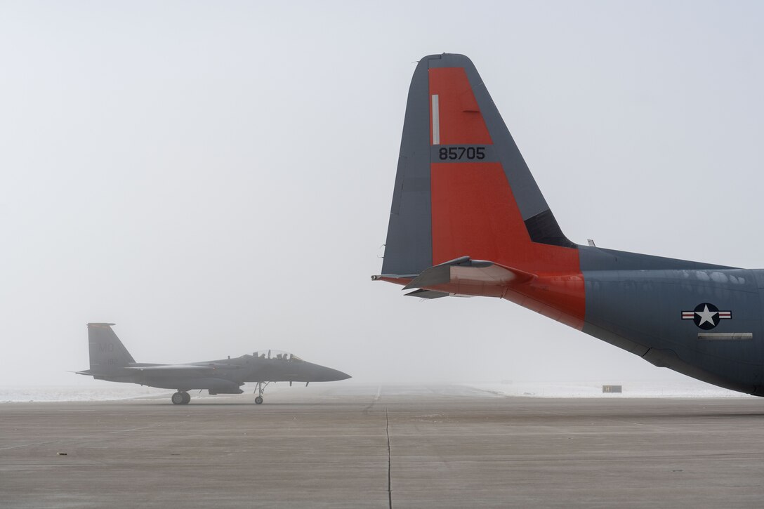 Photo of Airmen taxiing aircraft