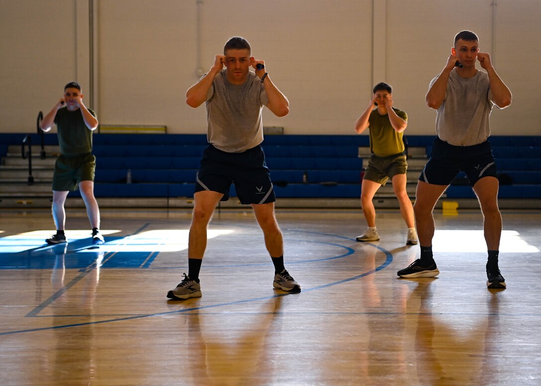 Military members in physical training uniforms.