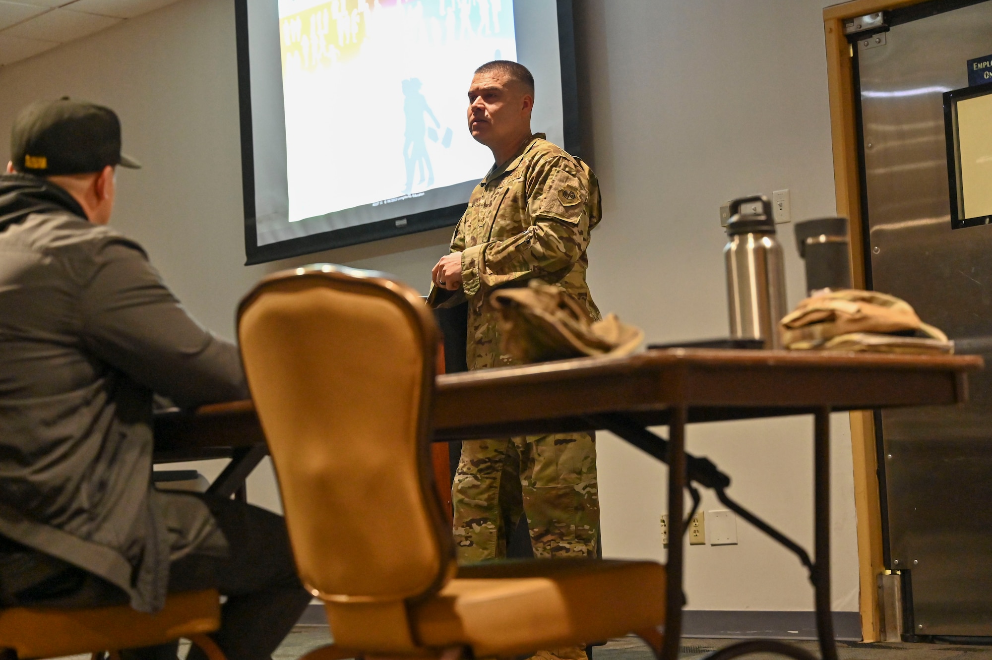 Pictured above is an Airman speaking with a large group of people.