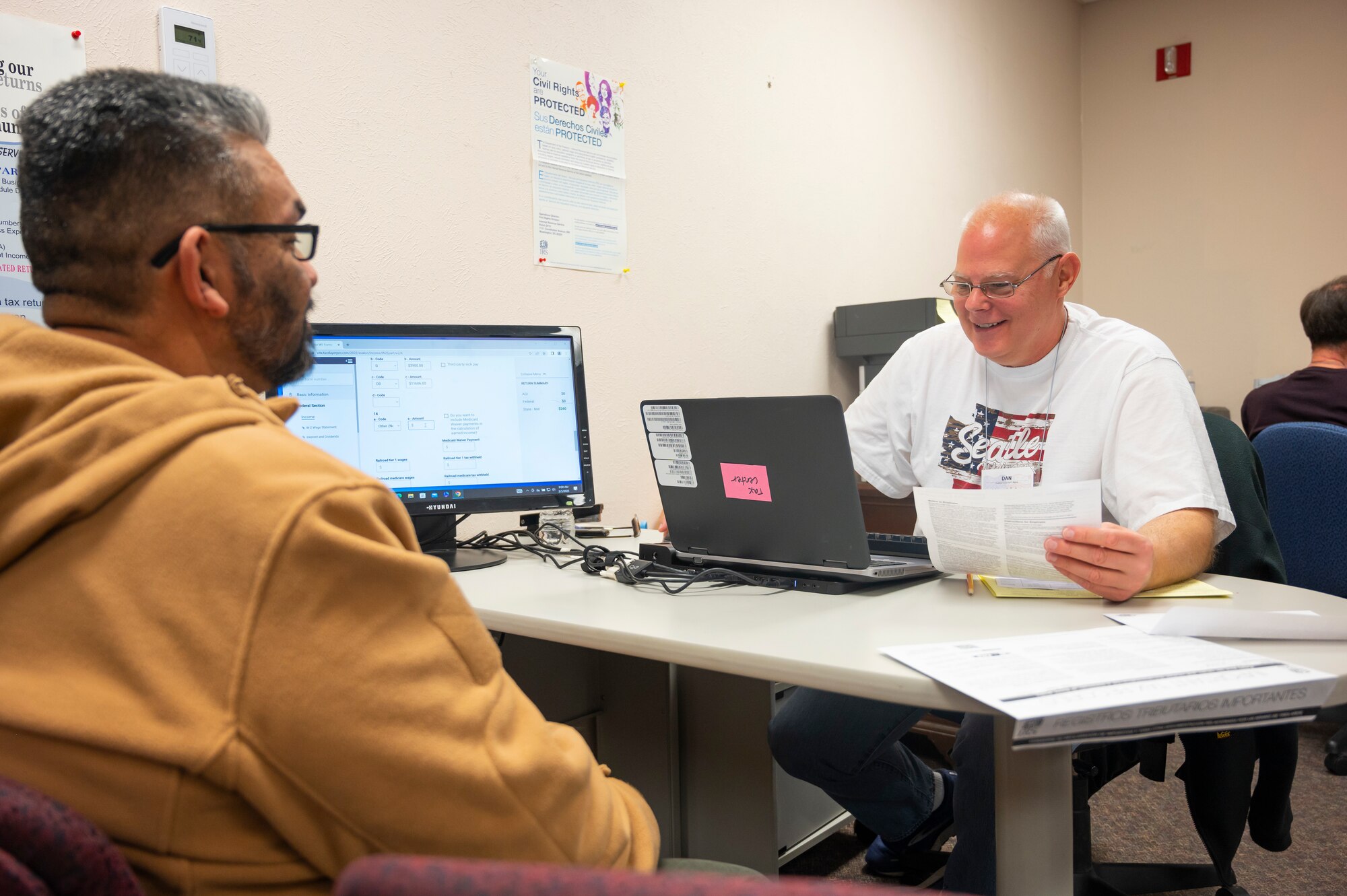 Man helps other man do taxes