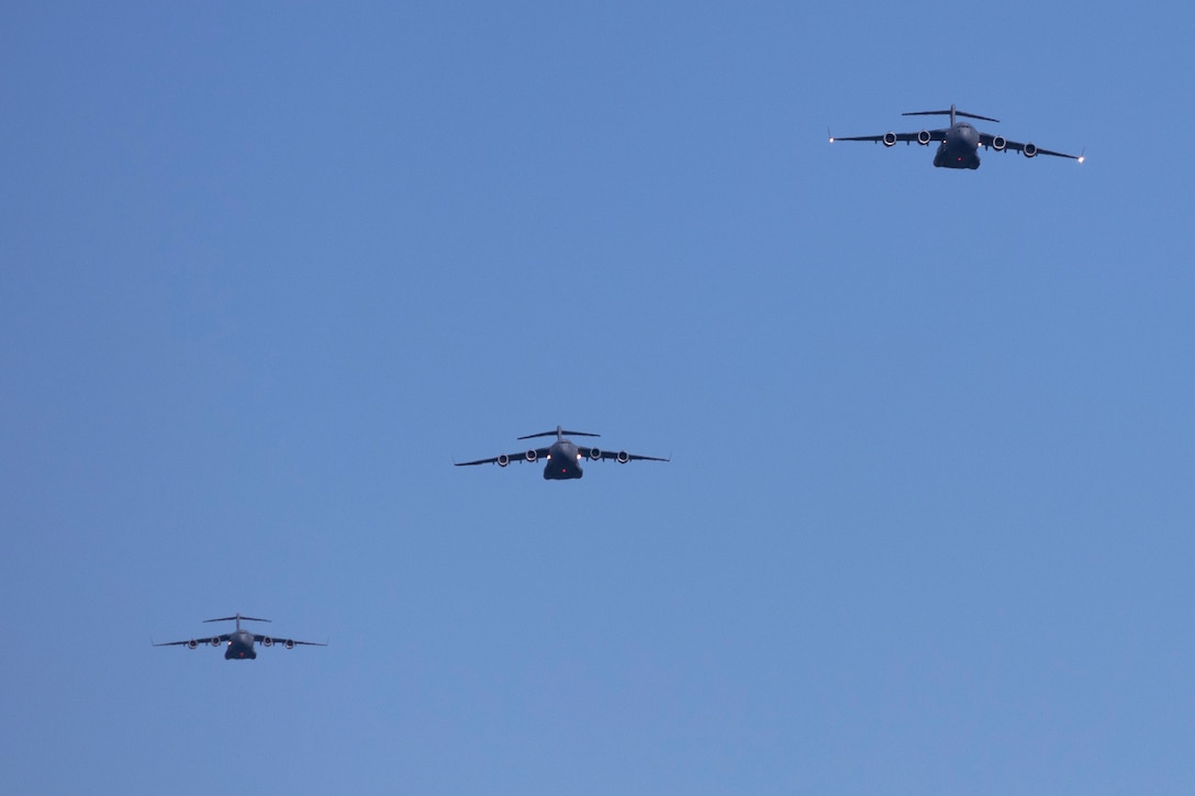 Three aircraft fly next to one another.