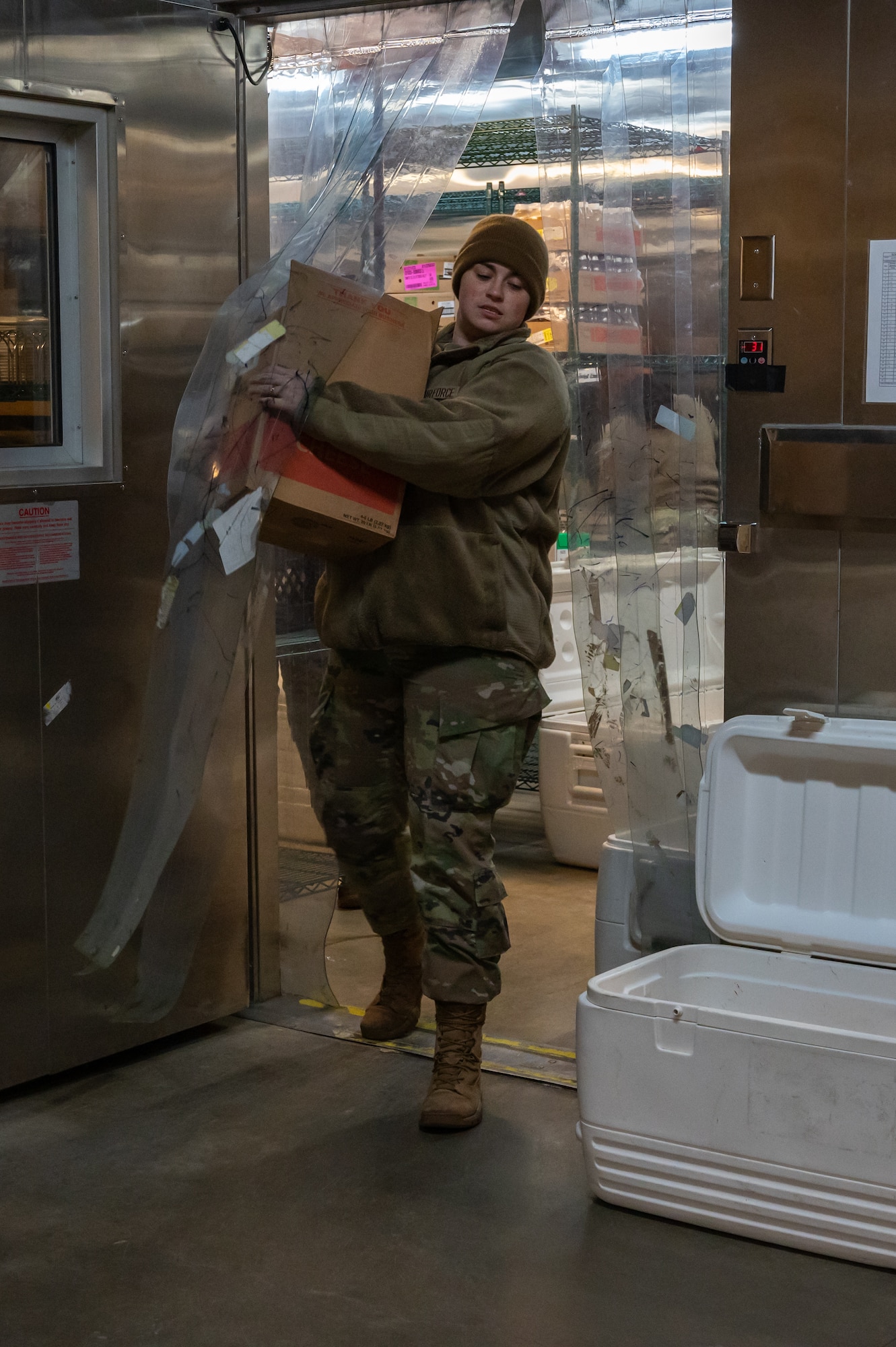 U.S. Airmen from the 5th Force Support Squadron pack supplies for use by chefs deployed to remote Missile Alert Facilities (MAFs) at Minot Air Force Base, North Dakota, Jan. 30, 2023.Airmen not deployed to a MAF pack rations to be delivered quickly to the missile sites around Minot, some sites reaching up to 75 miles away. (U.S. Air Force photo by Airman 1st Class Alexander Nottingham)