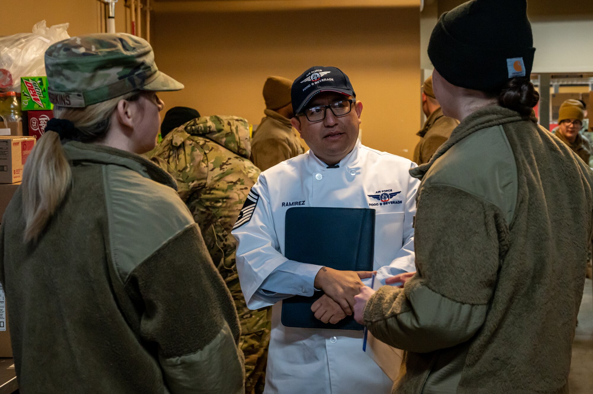 U.S. Airmen assigned to the 5th Force Support Squadron receive mentorship from a member of the Hennessy Award committee at Minot Air Force Base, North Dakota, Jan. 31, 2023. Minot AFB was one of two finalists for the 2023 Hennessy Award, which recognizes excellence in food service.  (U.S. Air Force photo by Airman 1st Class Alexander Nottingham)