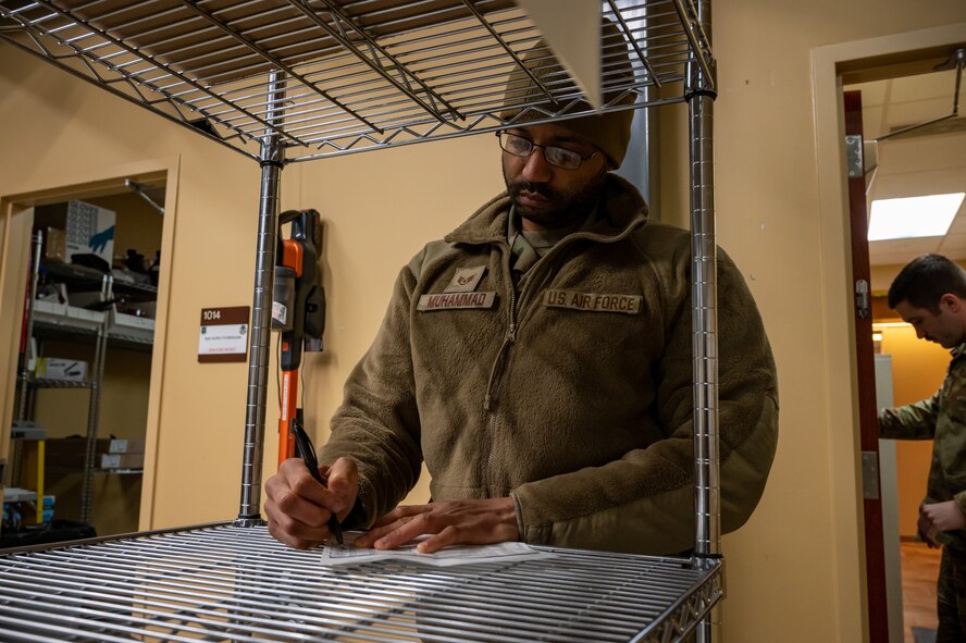 U.S. Airmen from the 5th Force Support Squadron pack supplies for use by chefs deployed to remote Missile Alert Facilities (MAFs) at Minot Air Force Base, North Dakota, Jan. 30, 2023.  Inventory is checked at every MAF to ensure an accurate re-stock. (U.S. Air Force photo by Airman 1st Class Alexander Nottingham)