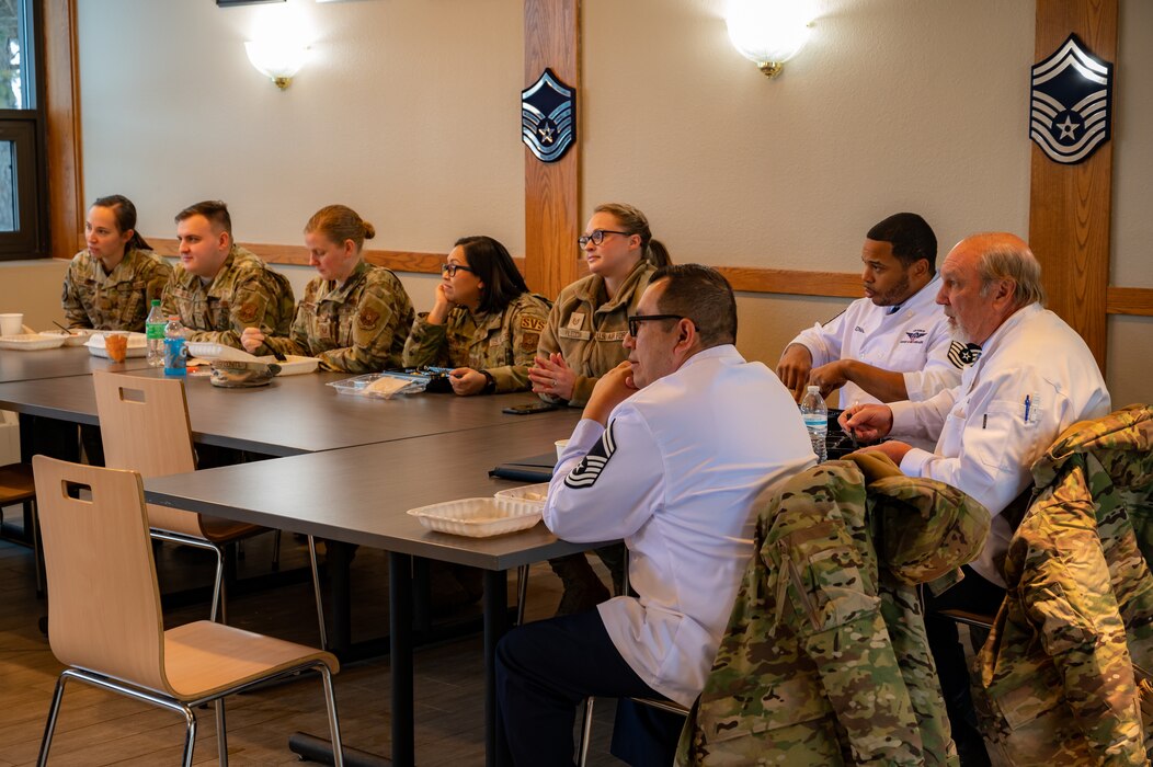 U.S. Airmen assigned to the 5th Force Support Squadron have a mentorship meeting  with a member of the Hennessy Award committee at Minot Air Force Base, North Dakota, Jan. 31, 2023. Minot AFB was one of two finalists for the 2023 Hennessy Award.  (U.S. Air Force photo by Airman 1st Class Alexander Nottingham)