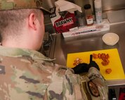 A 5th Force Support Squadron Missile Alert Facility (MAF) chef prepares a meal for Airmen deployed to the MAF near Minot Air Force Base, North Dakota, Feb. 1, 2023. A chef is deployed to each missile site to stay with the crew for the full deployment of at least one week. (U.S. Air Force photo by Senior Airman Micheal Richmond)