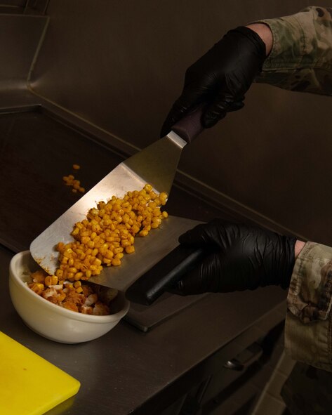 A 5th Force Support Squadron Missile Alert Facility (MAF) chef prepares a meal for Airmen deployed to the MAF near Minot Air Force Base, North Dakota, Feb. 1, 2023. A chef is deployed to each missile site to stay with the crew for the full deployment of at least one week. (U.S. Air Force photo by Senior Airman Micheal Richmond)