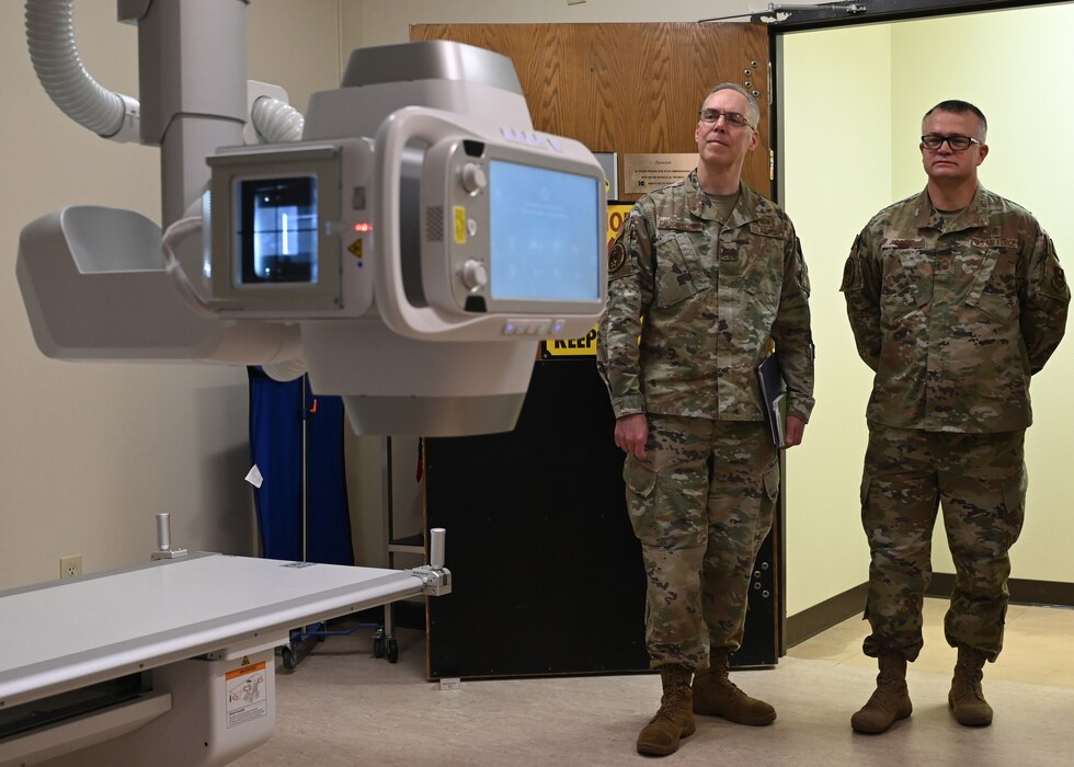 U.S. Air Force Col. Christopher Grussendorf, Air Education and Training Command command surgeon, and Chief Master Sgt. Donald Cook, AETC medical enlisted force chief, view a demonstration of the remote-controlled x-ray device at Ross Clinic, Texas, Feb. 3, 2023. An average of 15 individuals are observed with this machine per day. (U.S. Air Force photo by Airman 1st Class Zachary Heimbuch)