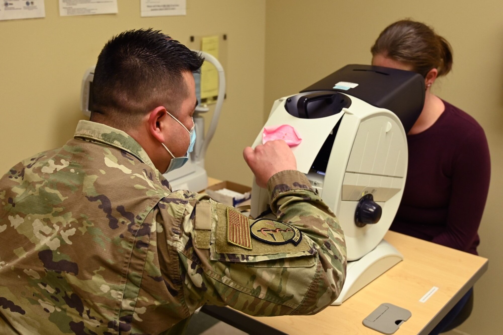 U.S. Air Force Staff Sgt. Jaime Carranza, flight medicine section chief with the 62d Medical Squadron, conducts a distant visual acuity test on a patient at Joint Base Lewis-McChord, Washington, Feb. 3, 2023. The distant visual acuity test is used to determine the smallest letters one can read on a standardized chart. (U.S. Air Force photo by Senior Airman Callie Norton)