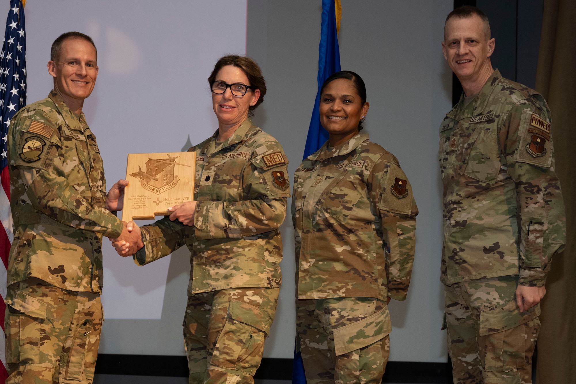 The 49th Healthcare Operations Squadron accepts the Small Unit of the Quarter Award, during the 49th Wing’s 4th Quarter Award ceremony at Holloman Air Force Base, New Mexico, Feb. 2, 2023. Quarterly award winners were selected based on their technical expertise, demonstration of leadership and job performance. (U.S. Air Force photo by Senior Airman Antonio Salfran)