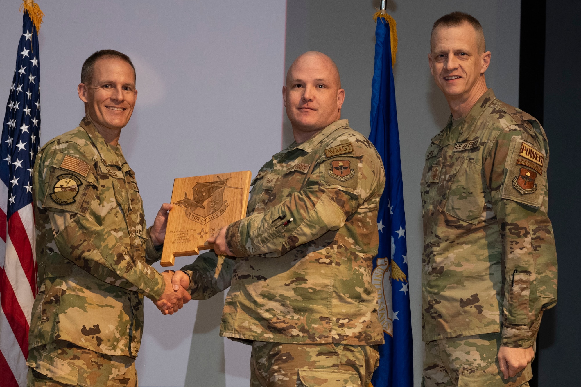 U.S. Air Force Staff Sgt. Nicholas Clum, from the 29th Attack Squadron, accepts the Volunteer of the Quarter Award, during the 49th Wing’s 4th Quarter Award ceremony at Holloman Air Force Base, New Mexico, Feb. 2, 2023. Quarterly award winners were selected based on their technical expertise, demonstration of leadership and job performance. (U.S. Air Force photo by Senior Airman Antonio Salfran)