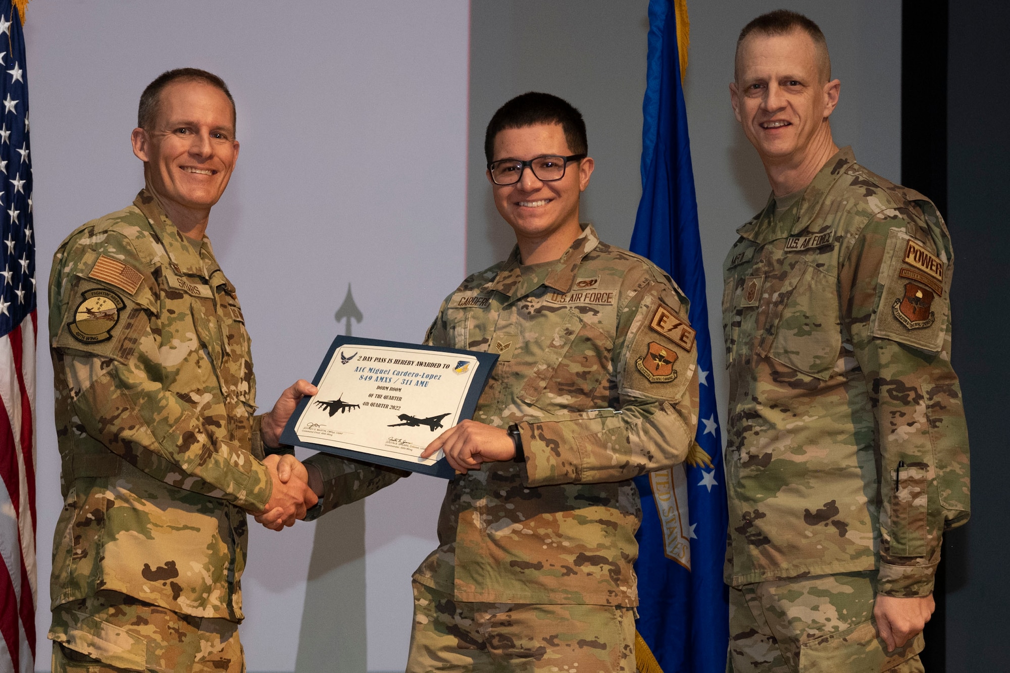 U.S. Air Force Airman 1st Class Miguel Cardero-Lopez, from the 849th Aircraft Maintenance Squadron, accepts the Dorm of the Quarter Award, during the 49th Wing’s 4th Quarter Award ceremony at Holloman Air Force Base, New Mexico, Feb. 2, 2023. Quarterly award winners were selected based on their technical expertise, demonstration of leadership and job performance. (U.S. Air Force photo by Senior Airman Antonio Salfran)