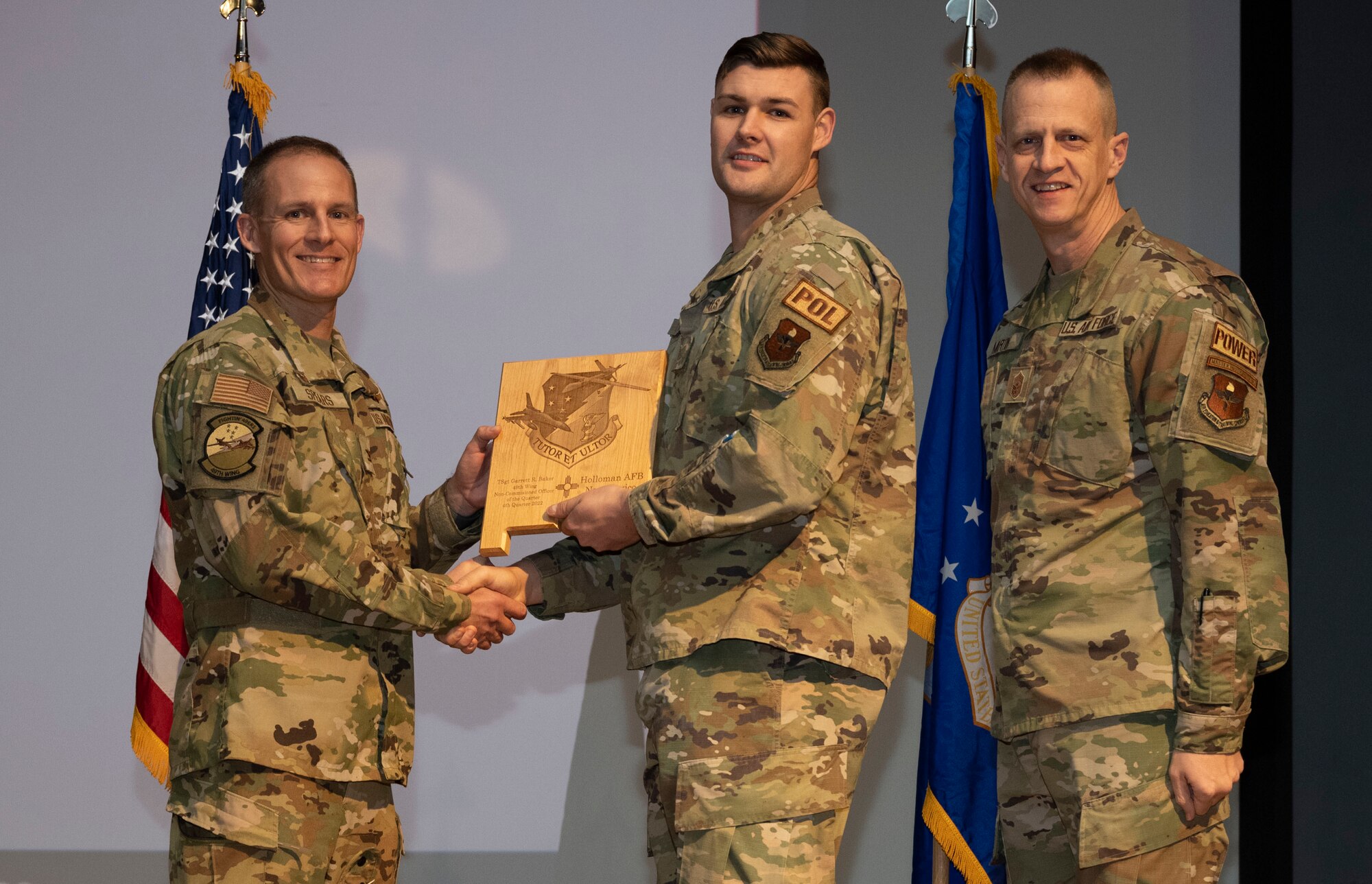U.S. Air Force Tech. Sgt. Garrett Baker, from the 49th Logistics Readiness Squadron, accepts the Non-commissioned Officer of the Quarter Award, during the 49th Wing’s 4th Quarter Award ceremony at Holloman Air Force Base, New Mexico, Feb. 2, 2023. Quarterly award winners were selected based on their technical expertise, demonstration of leadership and job performance. (U.S. Air Force photo by Senior Airman Antonio Salfran)