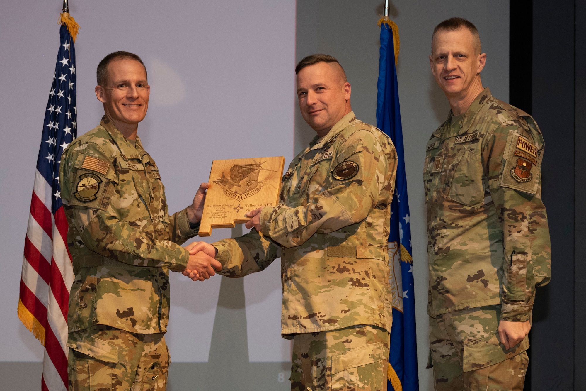 U.S. Air Force Master Sgt. Garrett Lehman, from the 29th Attack Squadron, accepts the Senior Non-commissioned Officer of the Quarter Award, during the 49th Wing’s 4th Quarter Award ceremony at Holloman Air Force Base, New Mexico, Feb. 2, 2023. Quarterly award winners were selected based on their technical expertise, demonstration of leadership and job performance. (U.S. Air Force photo by Senior Airman Antonio Salfran)