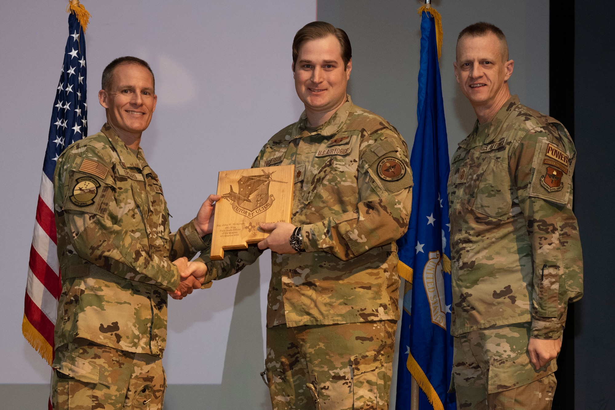 U.S. Air Force Maj. John Nickerson, from the 29th Attack Squadron, accepts the Field Grade Officer of the Quarter Award, during the 49th Wing’s 4th Quarter Award ceremony at Holloman Air Force Base, New Mexico, Feb. 2, 2023. Quarterly award winners were selected based on their technical expertise, demonstration of leadership and job performance. (U.S. Air Force photo by Senior Airman Antonio Salfran)