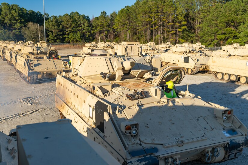 Tactical vehicles lined in rows.