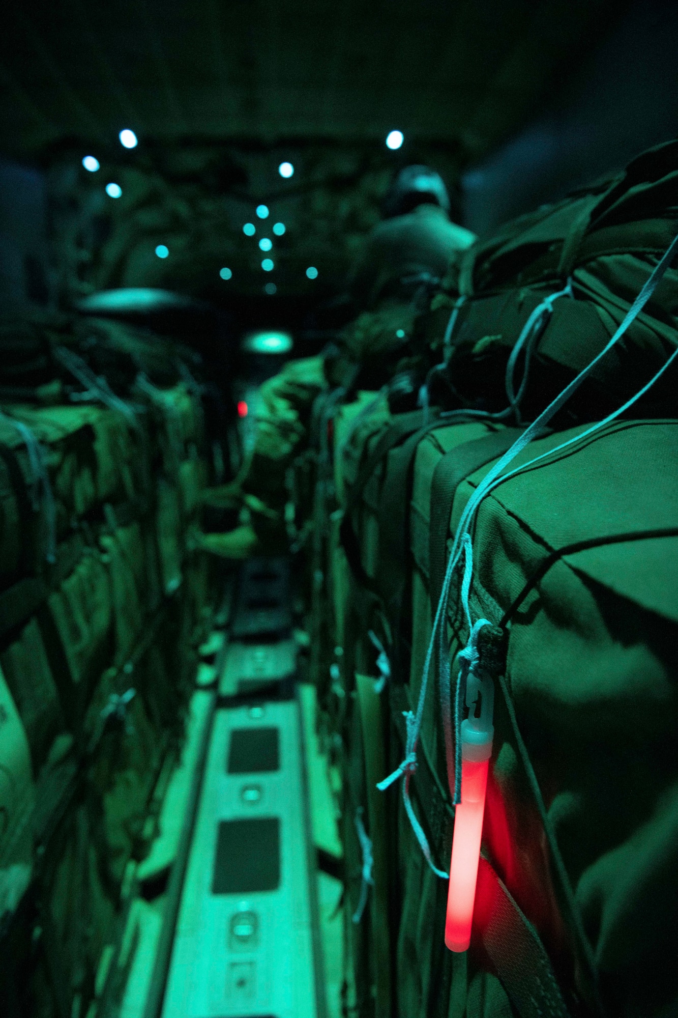 A light glows on the side of a cargo box in the rear cargo bay of a cargo aircraft
