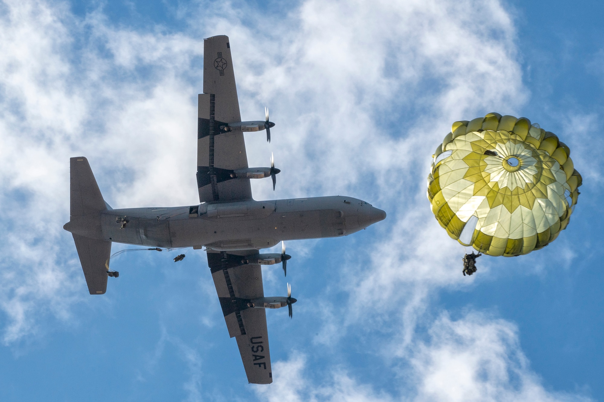 Japan Ground Self-Defense Force paratroopers assigned to the 1st Airborne Brigade descend from a U.S. Air Force C-130J Super Hercules assigned to the 36th Airlift Squadron over JGSDF East Fuji Maneuver Area, Japan, during Airborne 23, Jan. 31, 2023. 300 JGSDF paratroopers performed a static-line jump from Nine U.S. Air Force C-130J’s, showcasing the strategic importance of engaging in joint airborne operations. (U.S. Air Force photo by Yasuo Osakabe)