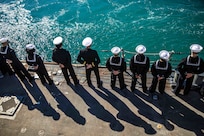 Sailors man the rails aboard the Arleigh Burke-class guided-missile destroyer USS Roosevelt (DDG 80) as the ship returns from patrol to Naval Station Rota, Feb. 4, 2023.