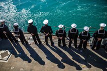 Sailors man the rails aboard the Arleigh Burke-class guided-missile destroyer USS Roosevelt (DDG 80) as the ship returns from patrol to Naval Station Rota, Feb. 4, 2023.
