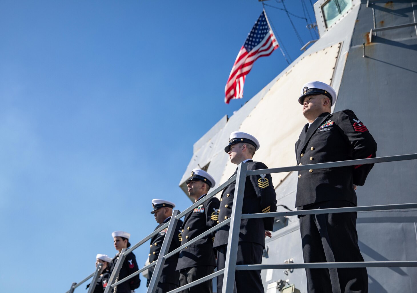 Sailors man the rails aboard the Arleigh Burke-class guided-missile destroyer USS Roosevelt (DDG 80) as the ship returns from patrol to Naval Station Rota, Feb. 4, 2023.