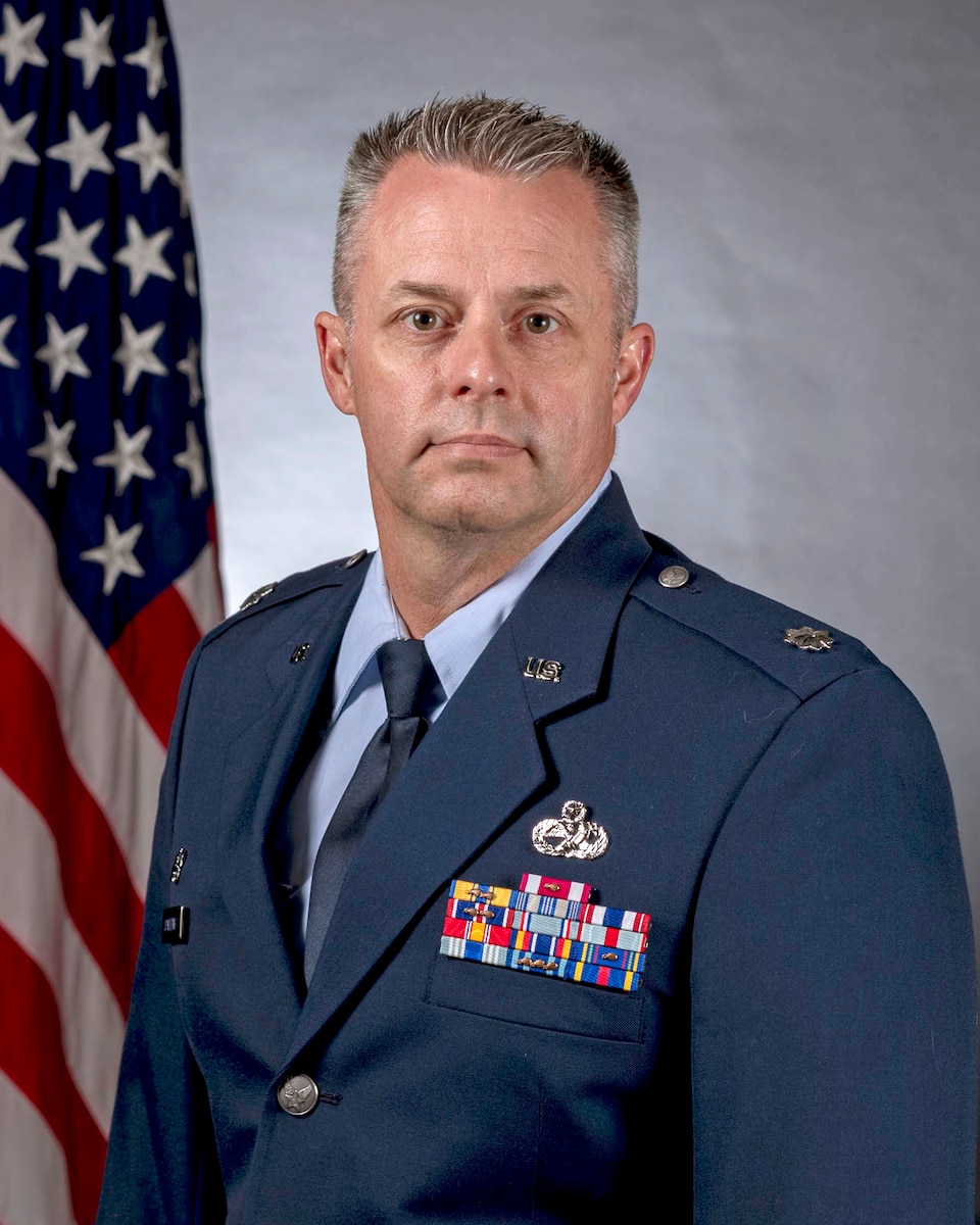 air force man in blue uniform poses for official photo