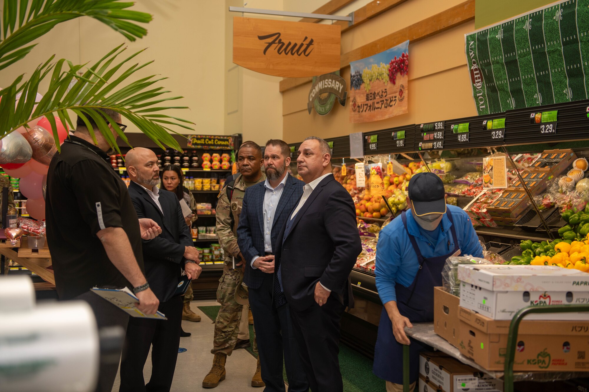 Under Secretary of Defense is briefed by commissary store manager.