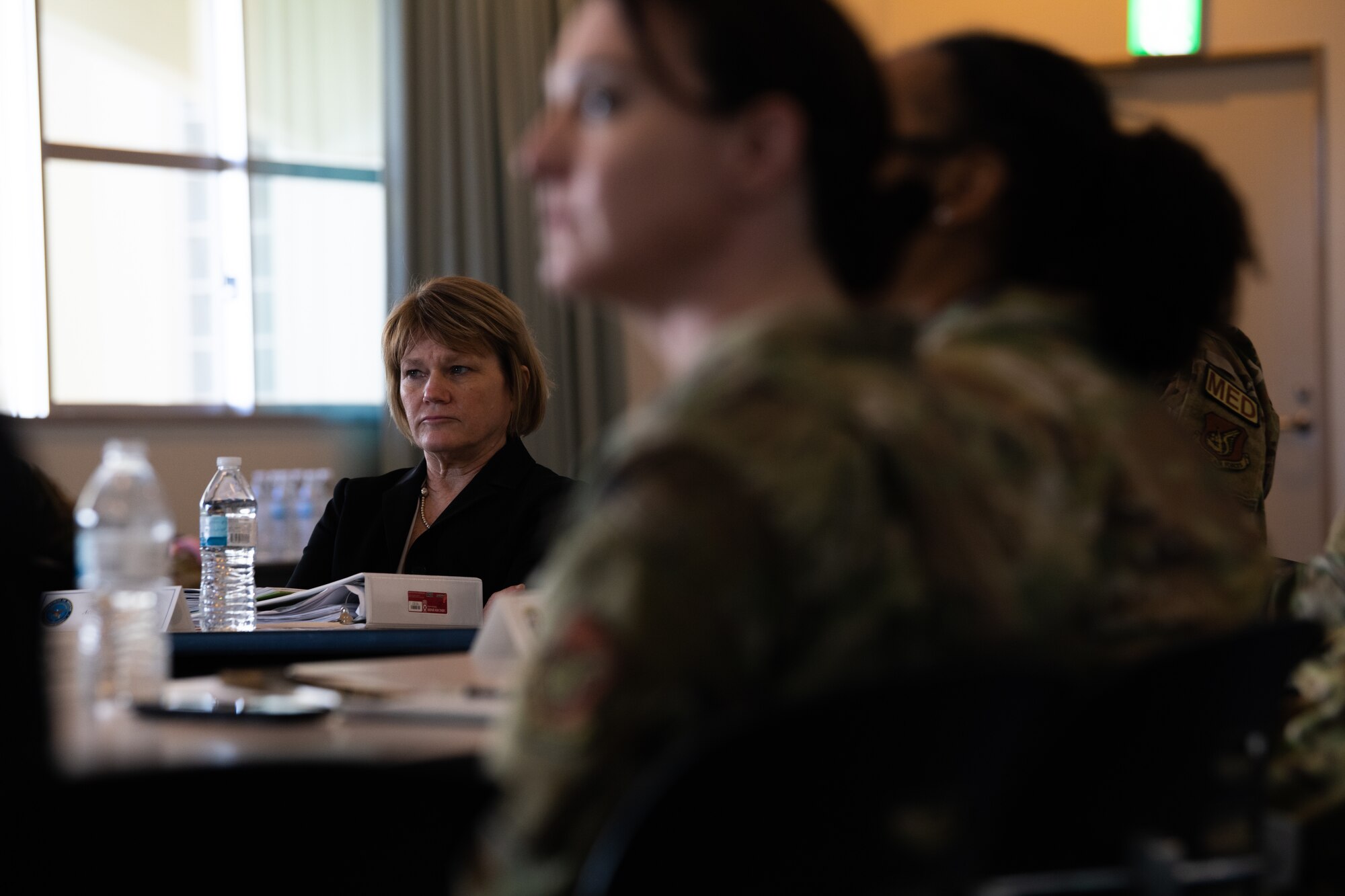 acting assistant Secretary of Defense listens to medical clinic Airmen