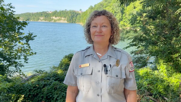 Park Ranger Judy Daulton stands in front of the shoreline of Lake Cumberland.