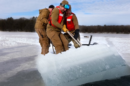 U.S. Navy Divers assigned to Mobile Diving Salvage Unit Two (MDSU 2) create a diving site on Ferrell Lake, Minnesota, Feb. 4, 2023 during Snow Crab Exercise 23-1, an exercise designed to test and evaluate U.S. Navy Explosive Ordnance Disposal’s (EOD) and Navy Diver’s capabilities and equipment in a simulated Arctic environment and improve combat effectiveness.  Navy EOD and Navy Divers are part of the Naval Expeditionary Combat Force (NECF), enabling the U.S. Navy Fleet by clearing and protecting the battlespace.