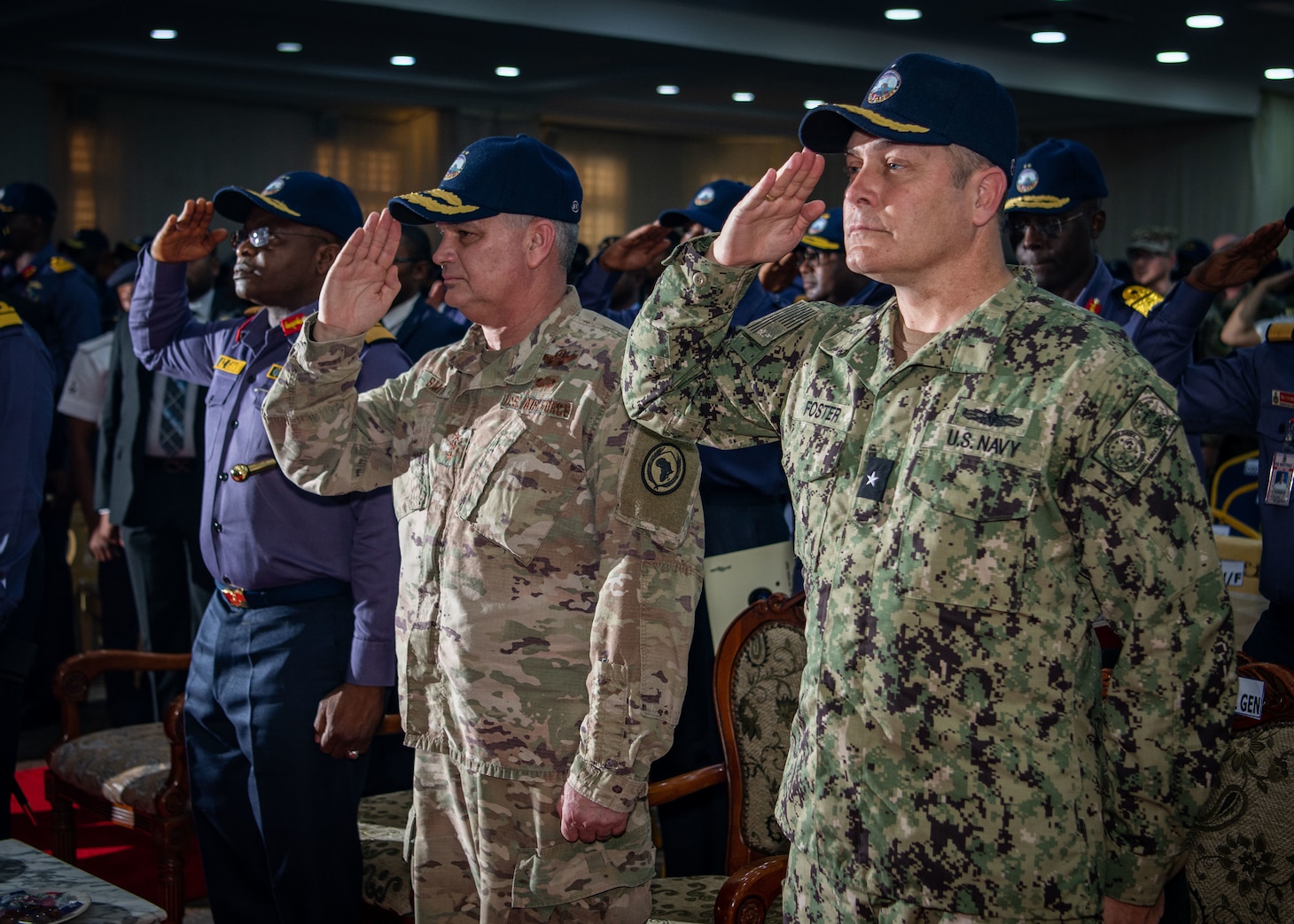 230203-N-DK722-1001 (Feb. 3, 2023) LAGOS, Nigeria – From right, U.S. Navy Rear Adm. Calvin Foster, director of the Maritime Partnership Program for U.S. Sixth Fleet, U.S. Air Force Lt. Gen. Kirk Smith, deputy commander of U.S. Africa Command, and Nigerian Navy Vice Adm. Awwal Gambo, Chief of Naval Staff, salute the Nigerian National Anthem during the Obangame Express 2023 closing ceremony in Lagos, Nigeria, Feb. 3, 2023. Obangame Express 2023, conducted by U.S. Naval Forces Africa, is a maritime exercise designed to improve cooperation, and increase maritime safety and security among participating nations in the Gulf of Guinea and Southern Atlantic Ocean. U.S. Sixth Fleet, headquartered in Naples, Italy, conducts the full spectrum of joint and naval operations, often in concert with allied and interagency partners, in order to advance U.S. national interests and security and stability in Europe and Africa. (U.S. Navy photo by Mass Communication Specialist 1st class Cameron C. Edy)