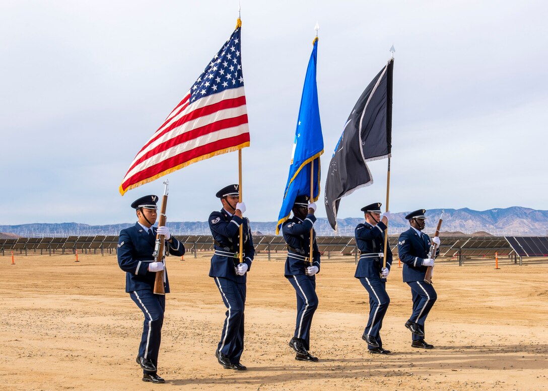 The Blue Eagles Honor Guard presents the colors for the National Anthem ahead of the  Edwards Solar Enhanced Use Lease Project ribbon cutting ceremony commemorating the largest private-public collaboration in Department of Defense history at Edwards Air Force Base, California, Feb. 2.