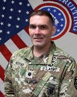 Male recruiting Soldier in front of United States and USAREC flags