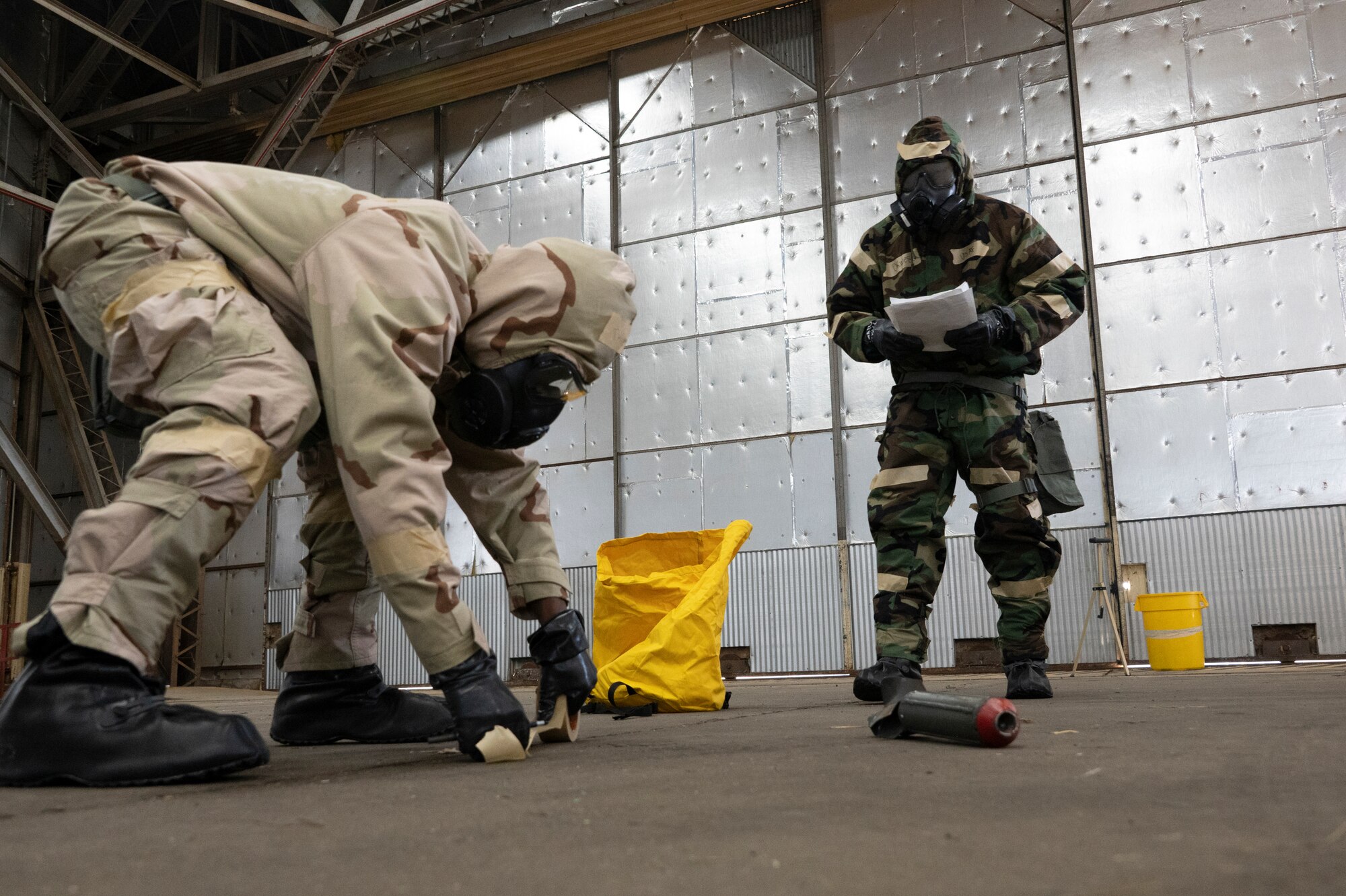 Airmen working in chemical warfare gear