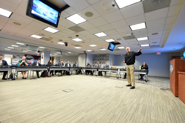 Chief of Naval Research Rear Adm. Lorin Selby addresses the incoming group of the  Navy Legislative Fellows program at the Office of Naval Research headquarters in Arlington, Virginia. The Navy Legislative Fellows program provides an opportunity for Navy, civilian, officers and senior enlisted to broaden their experience and knowledge in the operations and organization of Congress while enhancing the Navy's ability to fulfill its role in the national policy development process.  The fellowship consists of a year-long full-time assignment to the office of a U.S. Congressional member, either in the Senate or the House of Representatives, who serves on a defense-related committee. The Fellow serves as a member of the staff and is assigned duties and tasks based on the needs of the office.